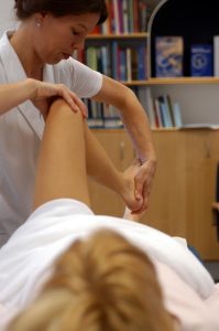 Osteopath treating knee pain